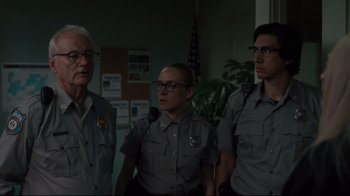 Movie still from “The Dead Don't Die” (2019), directed by Jim Jarmusch – A group of men standing next to each other; Medium shot, Low angle