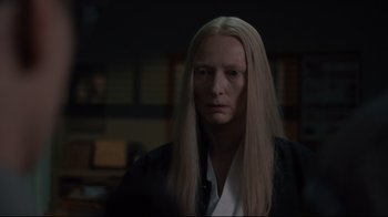 Movie still from “The Dead Don't Die” (2019), directed by Jim Jarmusch – A man with long blonde hair wearing a black shirt; Close Up shot, Over the shoulder angle