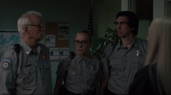 Movie still from “The Dead Don't Die” (2019), directed by Jim Jarmusch – A group of men standing next to each other; Medium shot, Low angle