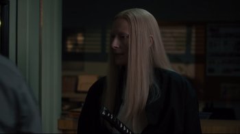 Movie still from “The Dead Don't Die” (2019), directed by Jim Jarmusch – A woman with long blonde hair is holding a guitar; Close Up shot, Over the shoulder angle