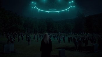 Movie still from “The Dead Don't Die” (2019), directed by Jim Jarmusch – A group of people standing in a field at night; Extreme Wide shot, High angle