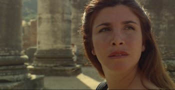 Movie still from “Climates” (2006), directed by Nuri Bilge Ceylan – A woman's face in front of an old building; Close Up shot, Low angle