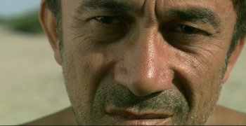 Movie still from “Climates” (2006), directed by Nuri Bilge Ceylan – A man's eyes and face; Extreme Close Up shot, Low angle