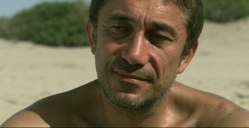 Movie still from “Climates” (2006), directed by Nuri Bilge Ceylan – A man's face on the beach; Close Up shot, Over the shoulder angle