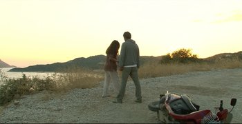Movie still from “Climates” (2006), directed by Nuri Bilge Ceylan – A man and a woman standing next to a motorcycle; Extreme Wide shot, High angle