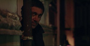 Movie still from “Climates” (2006), directed by Nuri Bilge Ceylan – A person leaning against a pole; Close Up shot, Low angle