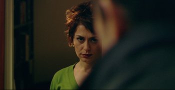 Movie still from “Climates” (2006), directed by Nuri Bilge Ceylan – A person looking at a mirror; Close Up shot, Over the shoulder angle