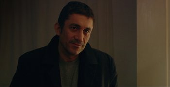 Movie still from “Climates” (2006), directed by Nuri Bilge Ceylan – A person wearing a jacket; Close Up shot, Over the shoulder angle