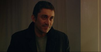 Movie still from “Climates” (2006), directed by Nuri Bilge Ceylan – A person wearing a jacket; Close Up shot, Over the shoulder angle