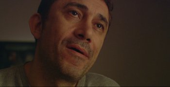 Movie still from “Climates” (2006), directed by Nuri Bilge Ceylan – A man's face looking up at the sky; Close Up shot, Low angle