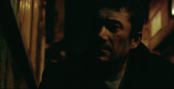 Movie still from “Climates” (2006), directed by Nuri Bilge Ceylan – A person in a dark room; Close Up shot, Over the shoulder angle