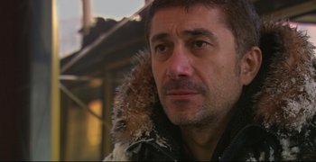 Movie still from “Climates” (2006), directed by Nuri Bilge Ceylan – A person wearing a jacket; Close Up shot, Over the shoulder angle