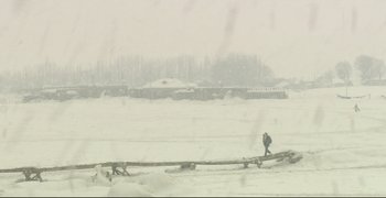 Movie still from “Climates” (2006), directed by Nuri Bilge Ceylan – A person walking across a snow covered field; Extreme Wide shot, High angle