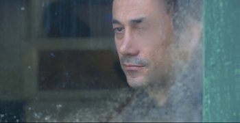 Movie still from “Climates” (2006), directed by Nuri Bilge Ceylan – A person looking out of a window; Close Up shot, Low angle