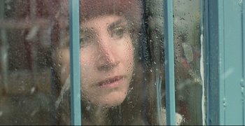 Movie still from “Climates” (2006), directed by Nuri Bilge Ceylan – A woman looking out of a window through a rain covered window; Close Up shot, Low angle