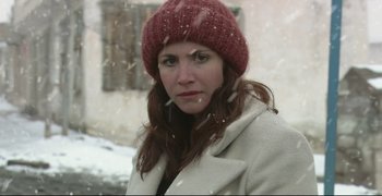 Movie still from “Climates” (2006), directed by Nuri Bilge Ceylan – A person wearing a coat and a hat; Close Up shot, Over the shoulder angle