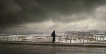 Movie still from “Climates” (2006), directed by Nuri Bilge Ceylan – A man standing on a bridge looking over a lake; Extreme Wide shot, Low angle