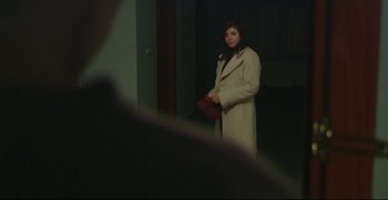 Movie still from “Climates” (2006), directed by Nuri Bilge Ceylan – A woman in a white coat holding a red purse; Medium shot, Over the shoulder angle