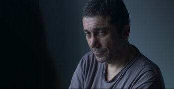 Movie still from “Climates” (2006), directed by Nuri Bilge Ceylan – A person sitting in front of a window; Close Up shot, Over the shoulder angle