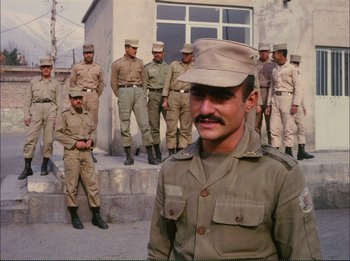 Movie still from “Close-Up” (1990), directed by Abbas Kiarostami – A group of men standing next to each other in uniform; Medium shot, Low angle
