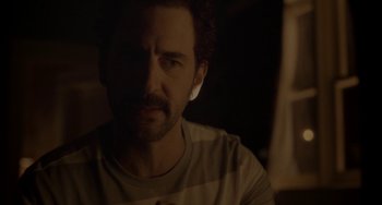Movie still from “Closet Monster” (2015), directed by Stephen Dunn – A person wearing a white shirt; Close Up shot, Over the shoulder angle