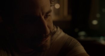 Movie still from “Closet Monster” (2015), directed by Stephen Dunn – A man's face in the dark; Close Up shot, Over the shoulder angle