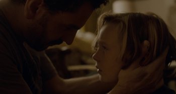 Movie still from “Closet Monster” (2015), directed by Stephen Dunn – A man and a little girl looking at each other; Close Up shot, Over the shoulder angle