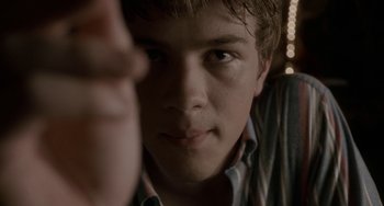 Movie still from “Closet Monster” (2015), directed by Stephen Dunn – A young man's face; Close Up shot, Low angle