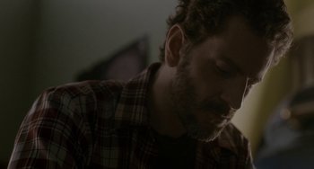 Movie still from “Closet Monster” (2015), directed by Stephen Dunn – A person wearing a plaid shirt; Close Up shot, Low angle