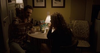 Movie still from “Closet Monster” (2015), directed by Stephen Dunn – A man and a woman sitting at a table; Medium shot, Over the shoulder angle