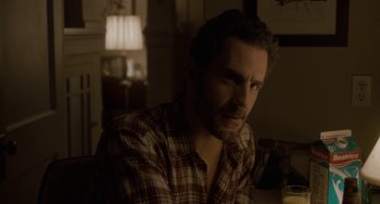 Movie still from “Closet Monster” (2015), directed by Stephen Dunn – A person sitting at a table; Close Up shot, Over the shoulder angle