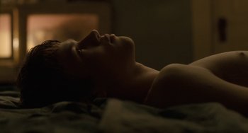 Movie still from “Closet Monster” (2015), directed by Stephen Dunn – A man laying on a bed with his eyes closed; Close Up shot, High angle