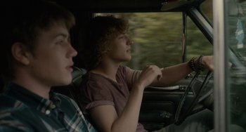 Movie still from “Closet Monster” (2015), directed by Stephen Dunn – Two young men sitting in the drivers seat of a car; Medium shot, Over the shoulder angle