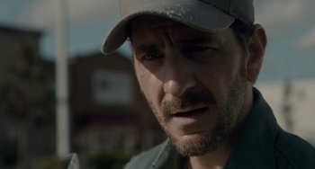 Movie still from “Closet Monster” (2015), directed by Stephen Dunn – A person wearing a hat; Close Up shot, Over the shoulder angle