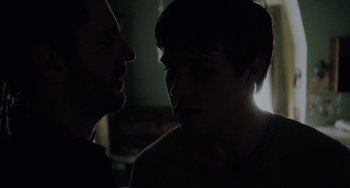 Movie still from “Closet Monster” (2015), directed by Stephen Dunn – Two men are facing each other in the dark; Close Up shot, Over the shoulder angle