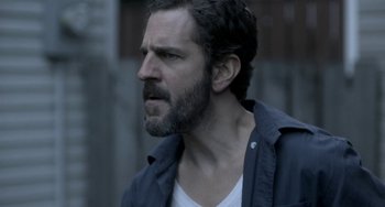 Movie still from “Closet Monster” (2015), directed by Stephen Dunn – A person with a beard; Close Up shot, Over the shoulder angle