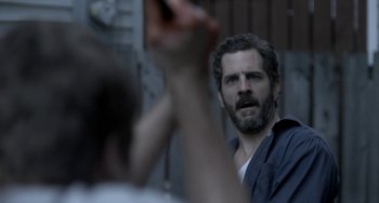 Movie still from “Closet Monster” (2015), directed by Stephen Dunn – A man with a goatee is looking at himself in the mirror; Close Up shot, Over the shoulder angle