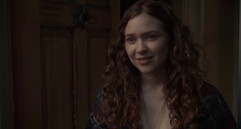 Movie still from “Closet Monster” (2015), directed by Stephen Dunn – A beautiful young woman with long brown curly hair; Close Up shot, Over the shoulder angle