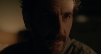 Movie still from “Closet Monster” (2015), directed by Stephen Dunn – A person with a beard; Extreme Close Up shot, Over the shoulder angle