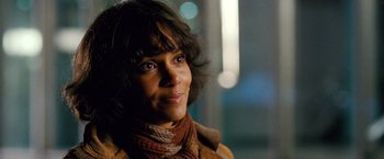 Movie still from “Cloud Atlas” (2012), directed by Lilly Wachowski – A person wearing a jacket and a scarf; Close Up shot, Over the shoulder angle