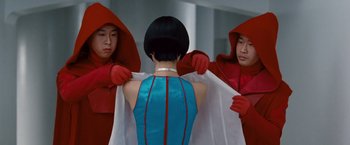 Movie still from “Cloud Atlas” (2012), directed by Lilly Wachowski – A group of people in red and blue costumes; Medium shot, Over the shoulder angle