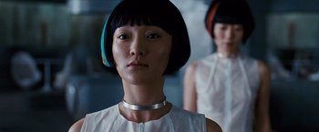 Movie still from “Cloud Atlas” (2012), directed by Lilly Wachowski – A woman with short black hair wearing a white top; Close Up shot, Low angle