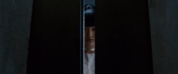 Movie still from “Cloud Atlas” (2012), directed by Lilly Wachowski – A woman with bangs looking through a window; Close Up shot, Low angle