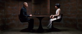 Movie still from “Cloud Atlas” (2012), directed by Lilly Wachowski – A man and a woman sitting at a table in front of each other; Wide shot, High angle
