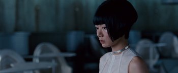 Movie still from “Cloud Atlas” (2012), directed by Lilly Wachowski – A woman with a short black hair wearing a white shirt; Close Up shot, Over the shoulder angle