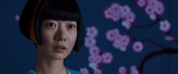 Movie still from “Cloud Atlas” (2012), directed by Lilly Wachowski – A person wearing a blue shirt; Close Up shot, Over the shoulder angle