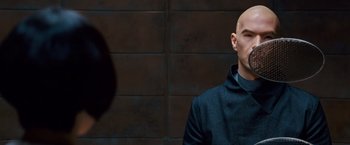 Movie still from “Cloud Atlas” (2012), directed by Lilly Wachowski – A bald man in a black jacket is looking to his left; Close Up shot, Over the shoulder angle