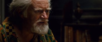 Movie still from “Cloud Atlas” (2012), directed by Lilly Wachowski – An old man with a white beard looking at the camera; Close Up shot, Over the shoulder angle