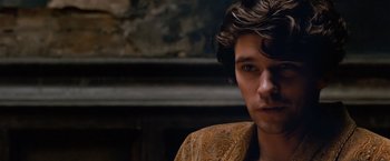 Movie still from “Cloud Atlas” (2012), directed by Lilly Wachowski – A person wearing a brown jacket; Close Up shot, Over the shoulder angle