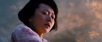 Movie still from “Cloud Atlas” (2012), directed by Lilly Wachowski – A person wearing a pink and white shirt; Close Up shot, Low angle